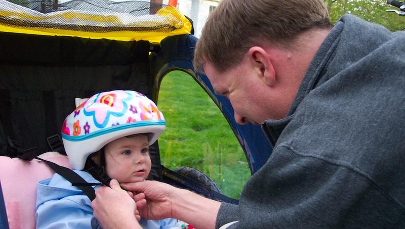 Early attempt to tow my daughter in a bicycle trailer before she could really even sit up on her own.